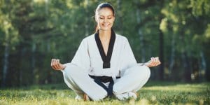 Martial Arts Lessons for Adults in Kansas City MO - Happy Woman Meditated Sitting Background